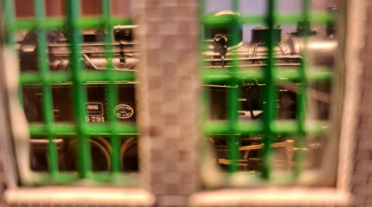 Looking out from the warehouses behind the harbour railway upon the busy shunting operations outside.